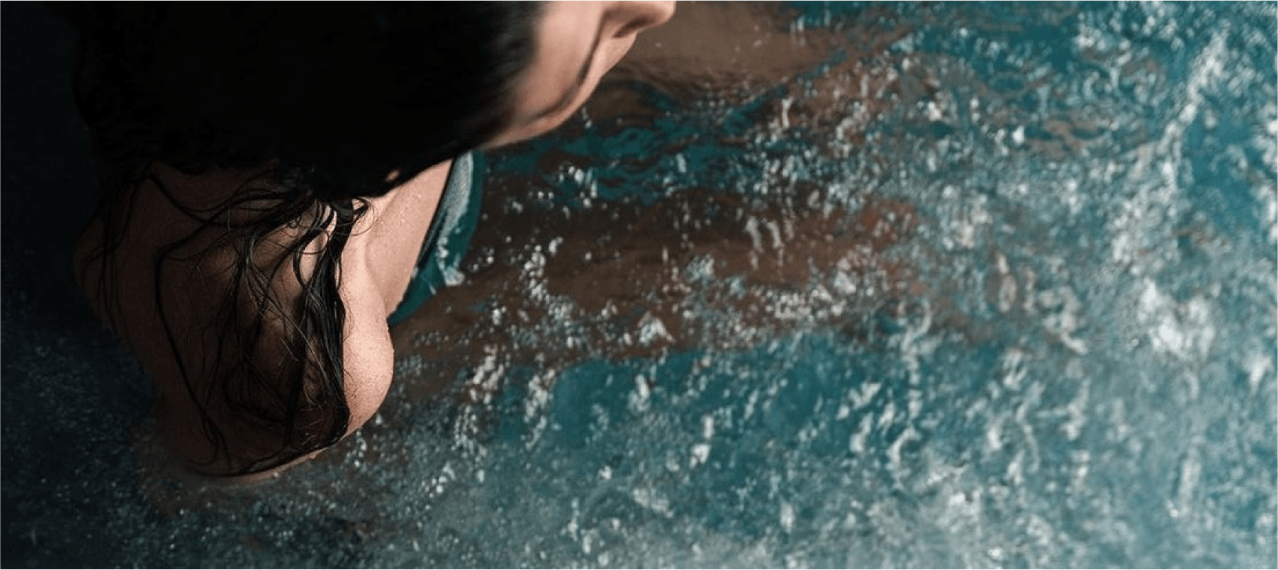 shoulder of a woman in a bluecube ice bath cold plunge tub