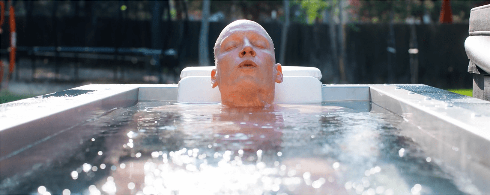 JP Crimini Breathwork Coach Cold Plunging in a BlueCube in his backyard