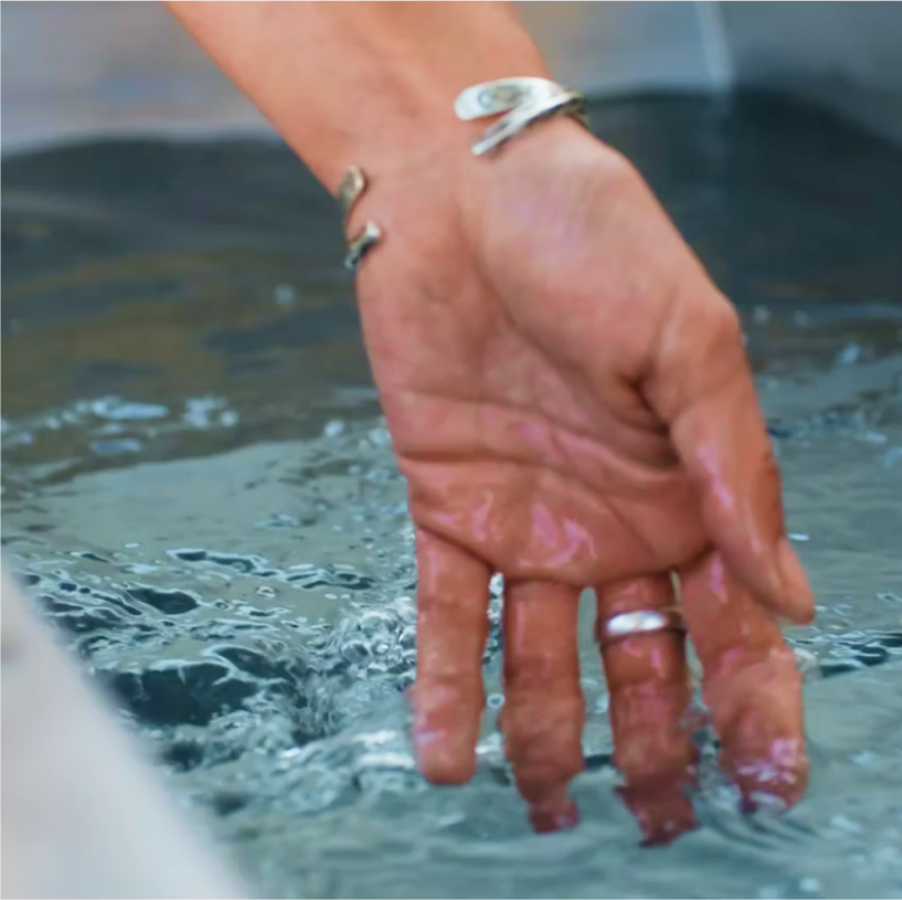 Woman With Her Hand in a BlueCube Cold Plunge water at 37F