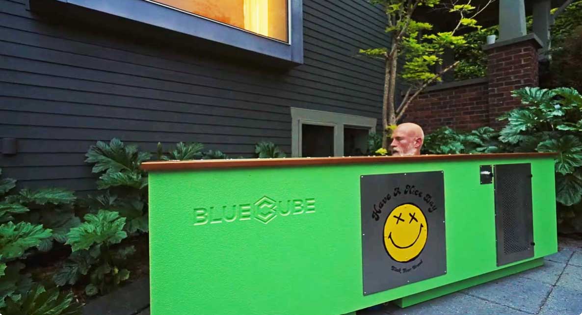Owner soaking in a custom BlueCube cold plunge at dusk