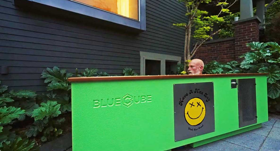 Owner soaking in a custom BlueCube cold plunge at dusk