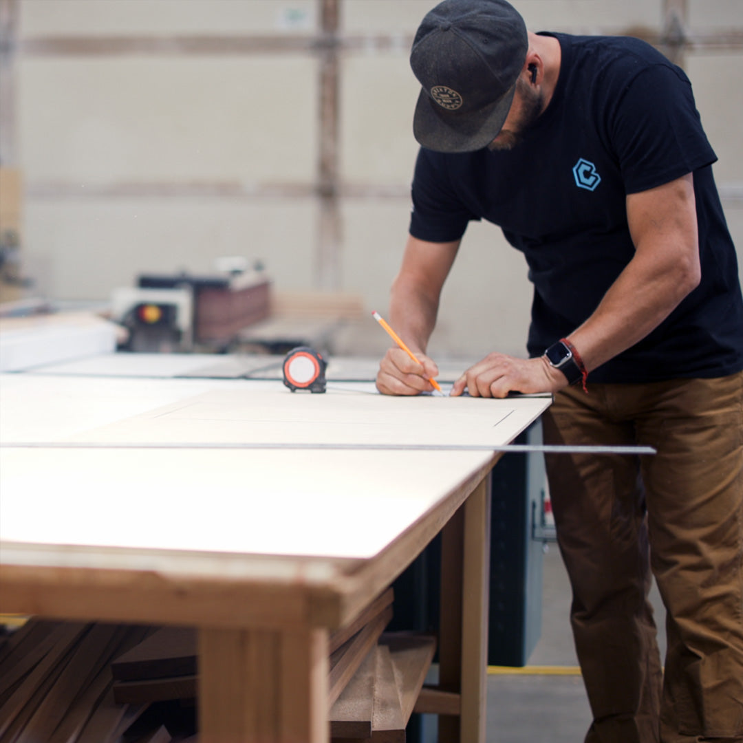 Clint measuring product builds and BlueCube headquarters. 