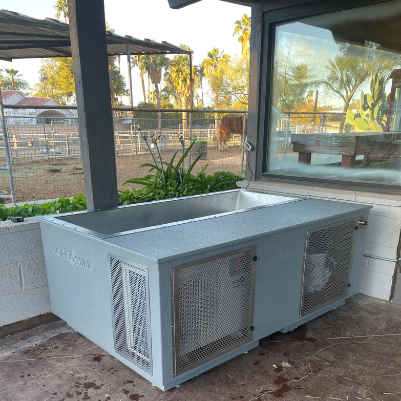 CoreChill Elite Cold Plunge Tub Grey placed outdoors on a farm