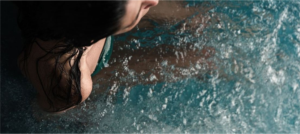 shoulder of a woman in a bluecube ice bath cold plunge tub