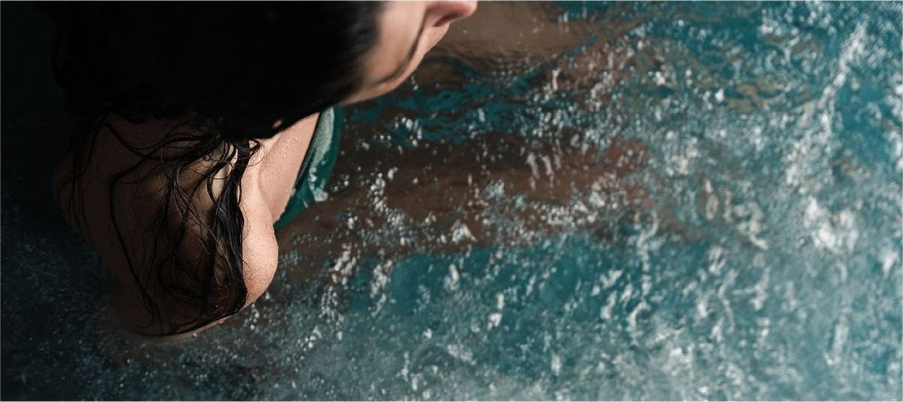 shoulder of a woman in a bluecube ice bath cold plunge tub