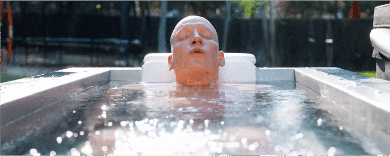JP Crimini Breathwork Coach Cold Plunging in a BlueCube in his backyard