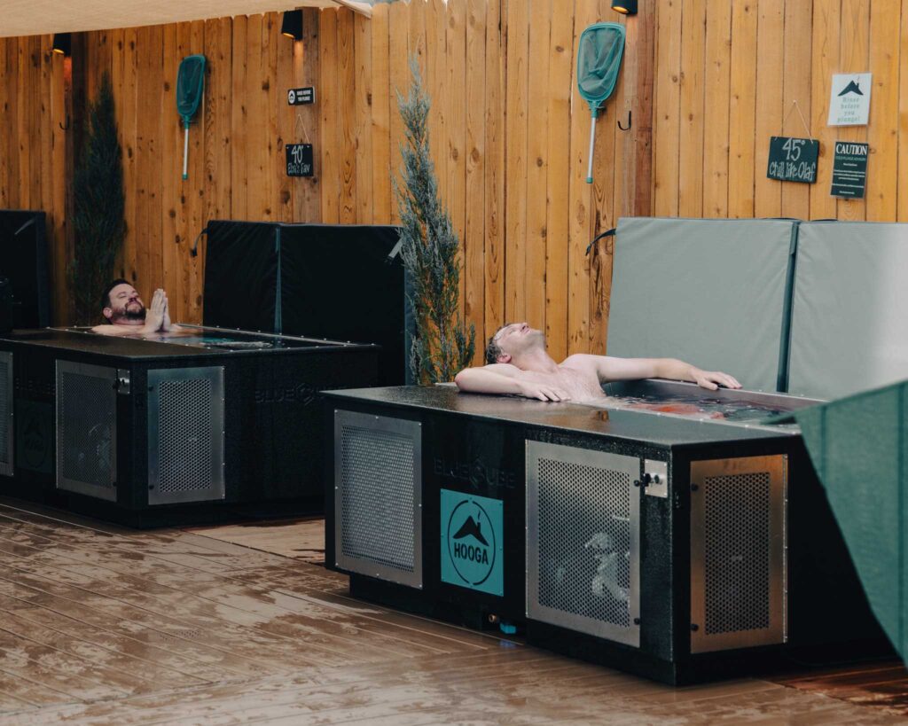 two black bluecube cold plunge ice baths at a contrast spa with a man in each unit