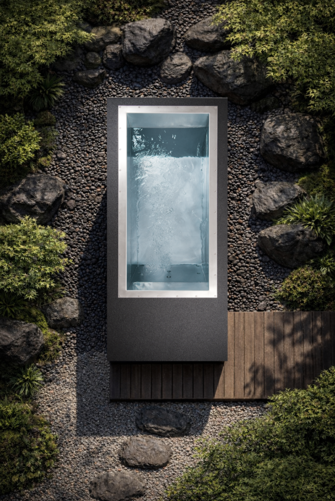 Black BlueCube C2 Luxury Cold Plunge Outside in a rock garden top view