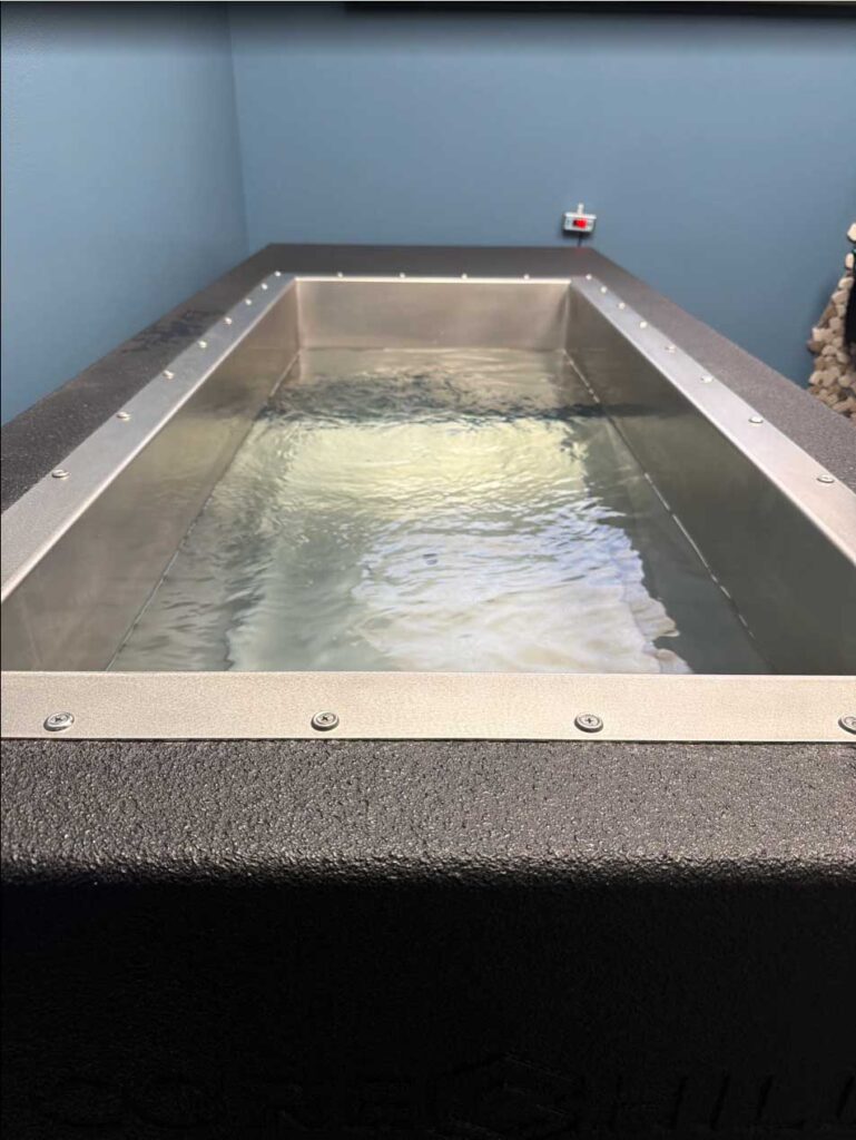 Overhead view of the stainless steel basin in a BlueCube C2 black cold plunge at The Stretch Garden in Riverhead, NY