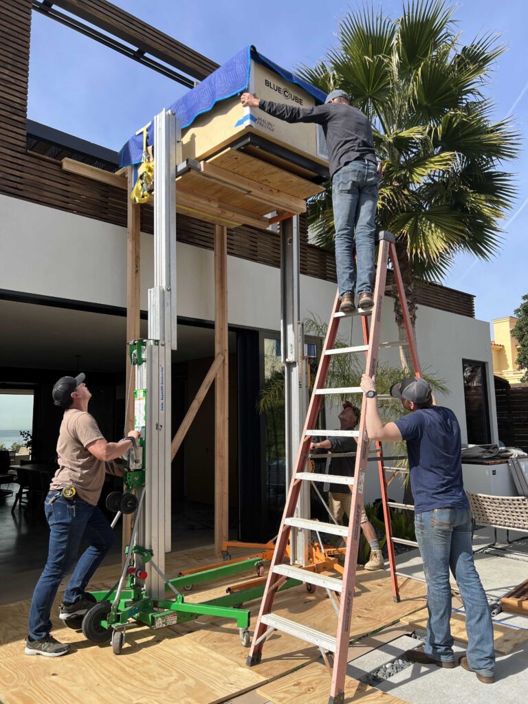 BlueCube install crew lifting a custom C3 cold plunge to Jocko Willink's rooftop deck