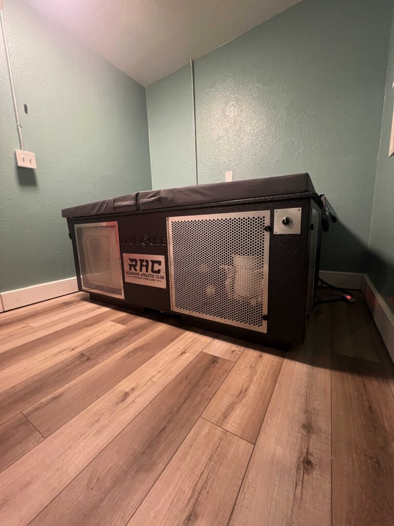 Side profile of a custom BlueCube C3 black cold plunge featuring co-branded Redmond Athletic Club plaque in Redmond, OR