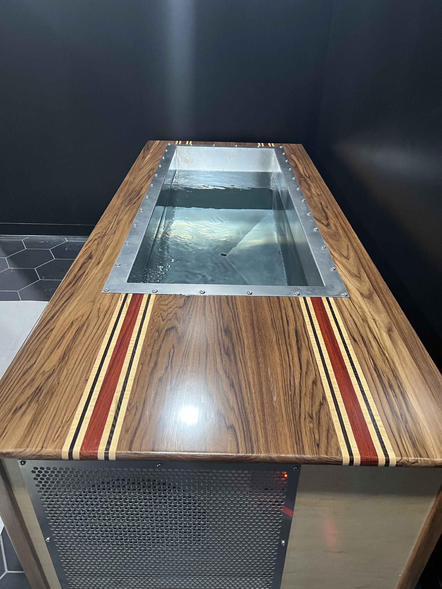 The first BlueCube's stainless tub and inlaid wood streamers — teak, padauk, wenge, and ambrosia maple